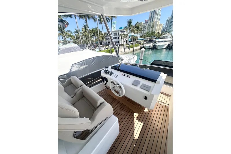 Slide: The Image of Luxurious helm of 2026 Astondoa 66 Fly yacht with modern controls and seating. - 13