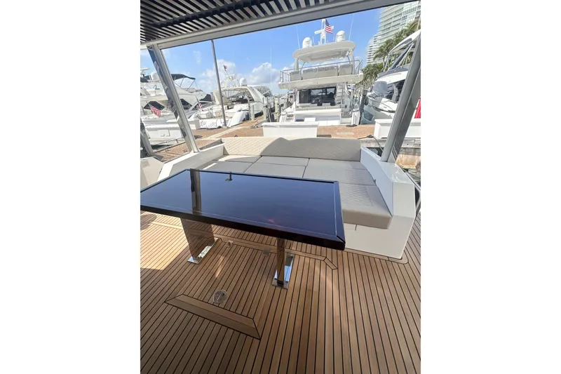 Slide: The Image of Luxurious 2026 Astondoa 66 Fly yacht deck with sleek seating and modern table. - 3