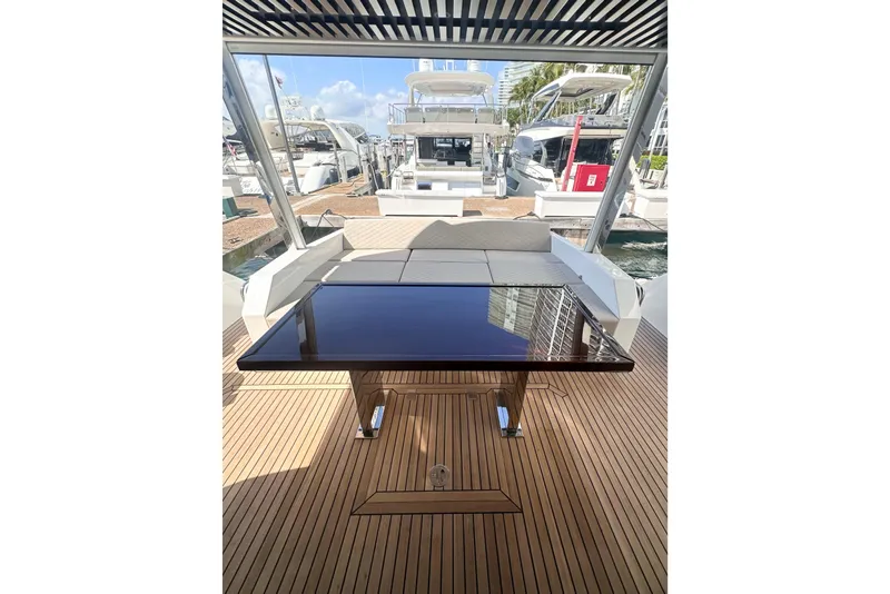 Slide: The Image of Astondoa 66 Fly 2026 yacht deck with sleek table and seating area. - 4