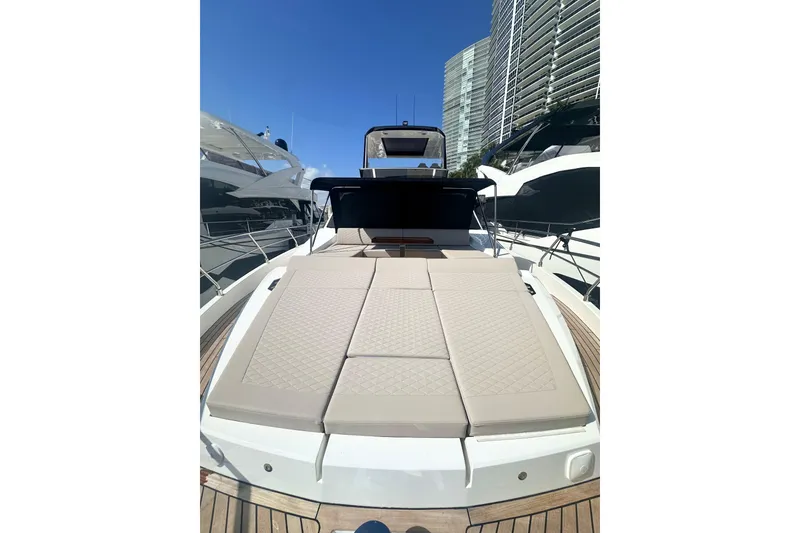 Slide: The Image of Luxurious 2026 Astondoa 66 Fly yacht with spacious sunbathing deck, docked in marina. - 8