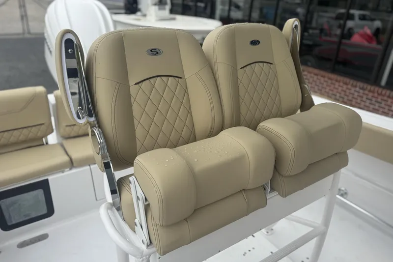 Slide: The Image of 2026 Sportsman Heritage 231 Center Console boat seats with tan upholstery and diamond stitching. - 11