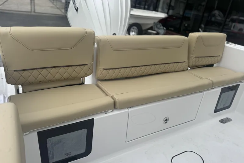 Slide: The Image of 2026 Sportsman Heritage 231 Center Console boat with beige cushioned seating. - 12