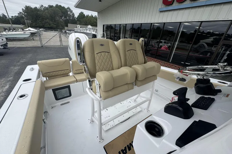 Slide: The Image of 2026 Sportsman Heritage 231 Center Console boat with beige seating and modern controls. - 18