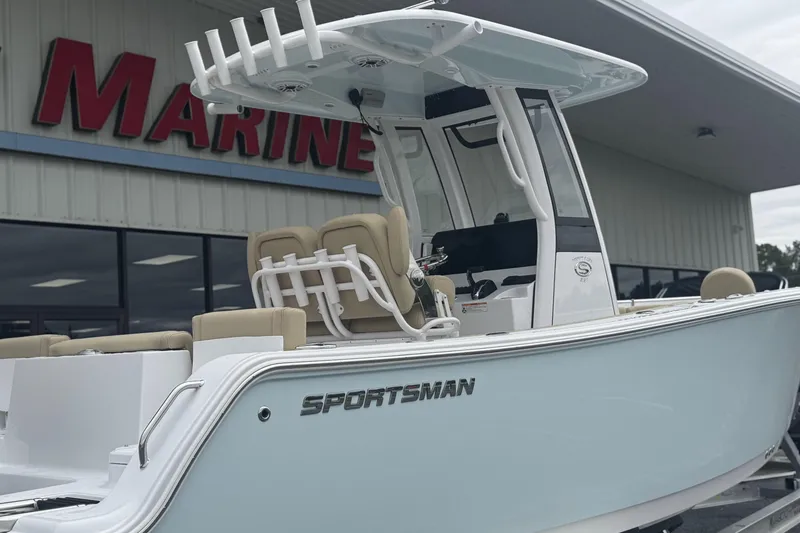 Slide: The Image of 2026 Sportsman Heritage 231 Center Console boat displayed outside marine store. - 3