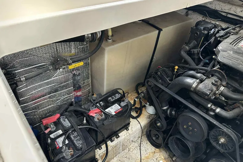 Slide: The Image of Engine compartment of a 2003 Rinker Fiesta Vee 290 boat, showing batteries and mechanical components. - 10