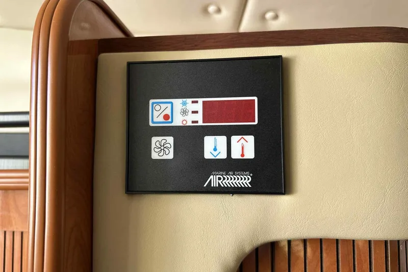 Slide: The Image of Control panel of a 2003 Rinker Fiesta Vee 290 boat, featuring temperature and fan settings. - 12
