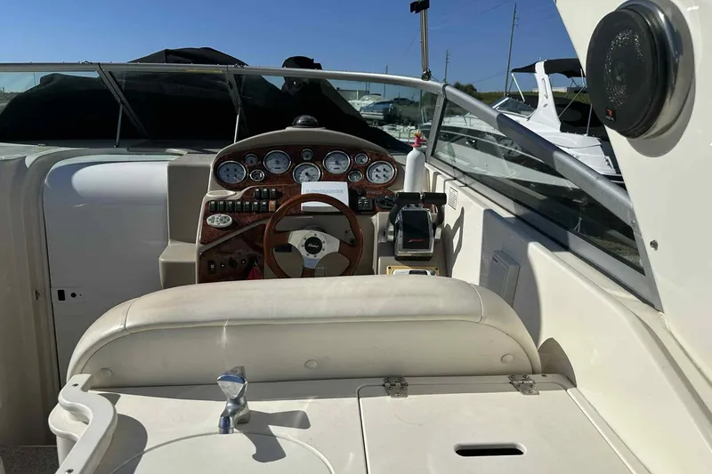 Slide: The Image of 2003 Rinker Fiesta Vee 290 boat cockpit with steering wheel and control panel. - 25