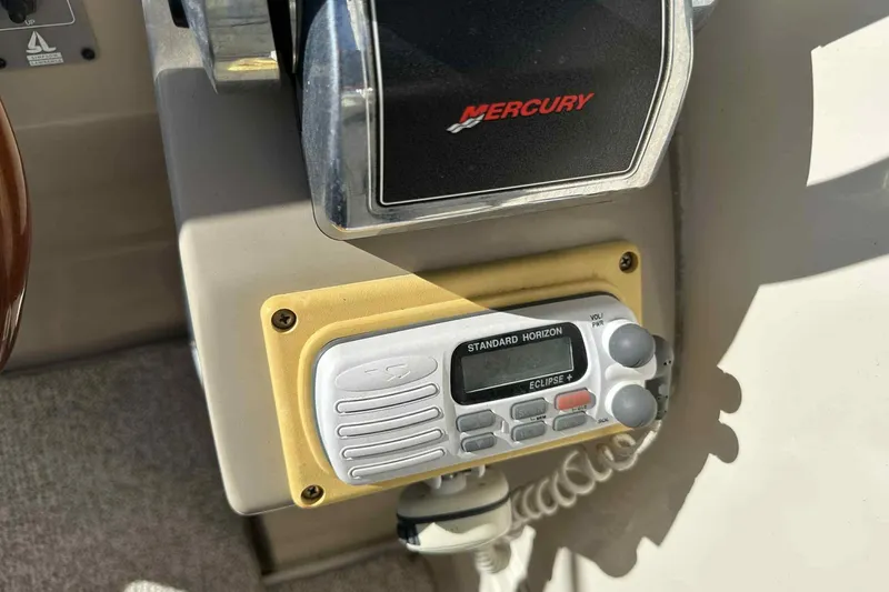 Slide: The Image of 2003 Rinker Fiesta Vee 290 boat controls with Mercury throttle and Standard Horizon radio. - 29