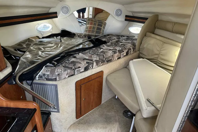 Slide: The Image of Interior cabin of 2003 Rinker Fiesta Vee 290 boat with seating and bedding. - 32