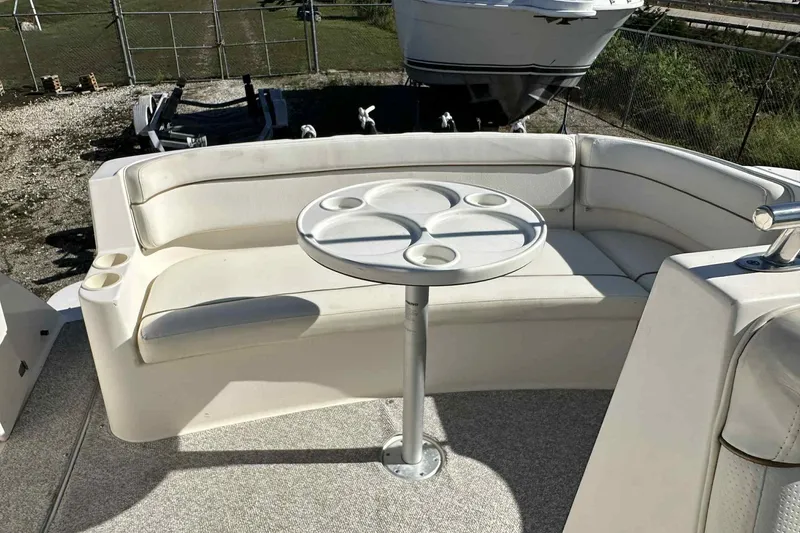 Slide: The Image of 2003 Rinker Fiesta Vee 290 boat with white seating and round table on deck. - 33
