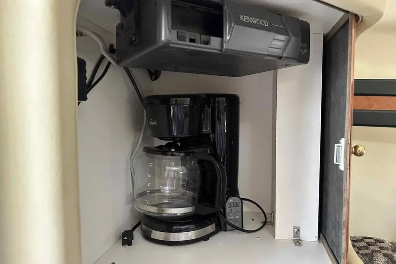 Slide: The Image of Coffee maker and Kenwood stereo in 2003 Rinker Fiesta Vee 290 boat cabin. - 6