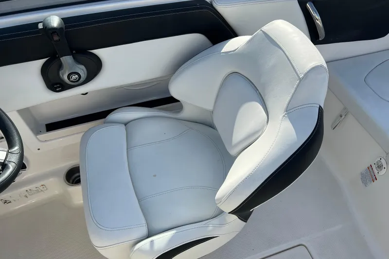 Slide: The Image of 2017 Chaparral 19 H2O Sport boat interior with white captain's seat and control panel. - 10