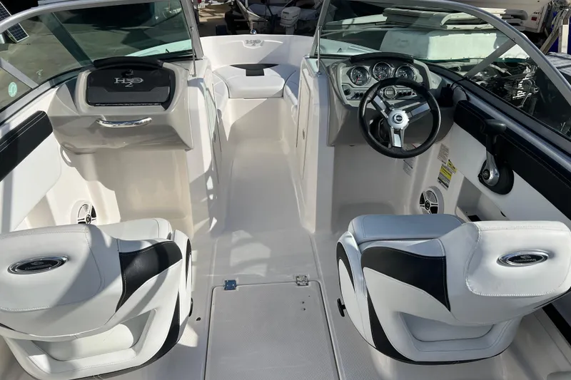 Slide: The Image of 2017 Chaparral 19 H2O Sport boat interior with steering wheel and seating. - 11