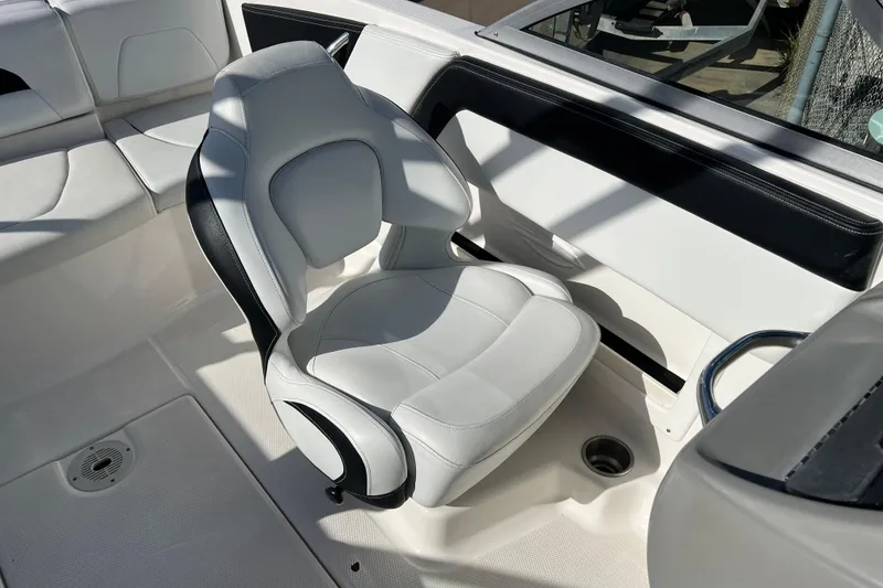Slide: The Image of 2017 Chaparral 19 H2O Sport boat interior with white seating and black accents. - 12
