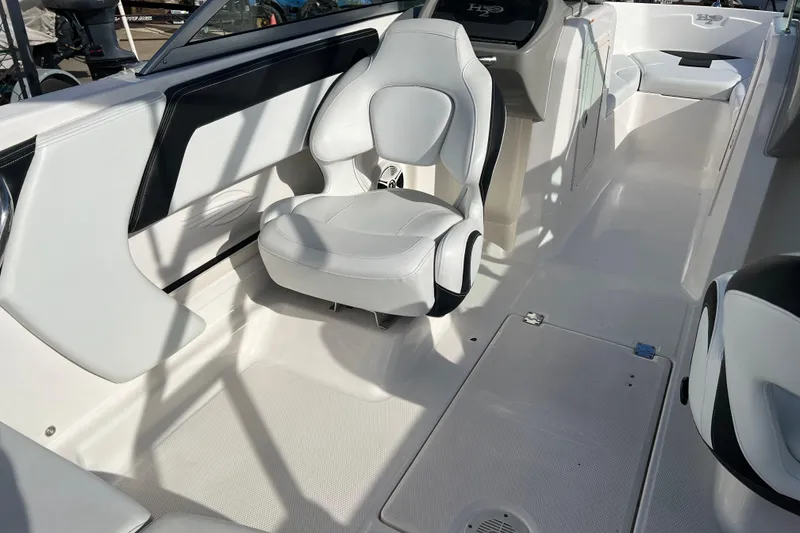 Slide: The Image of 2017 Chaparral 19 H2O Sport boat interior with white seating and sleek design. - 13