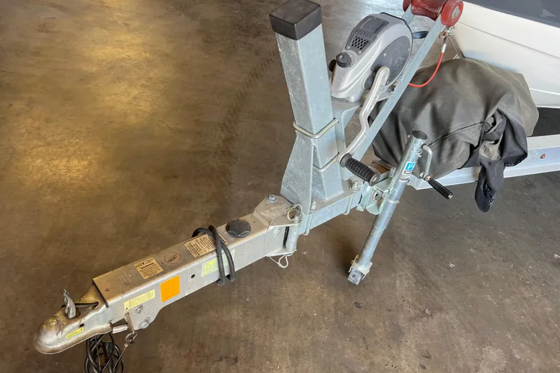 Slide: The Image of Trailer hitch of a 2017 Chaparral 19 H2O Sport boat in a garage setting. - 19