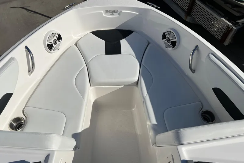 Slide: The Image of 2017 Chaparral 19 H2O Sport boat interior with white seating and speakers. - 8