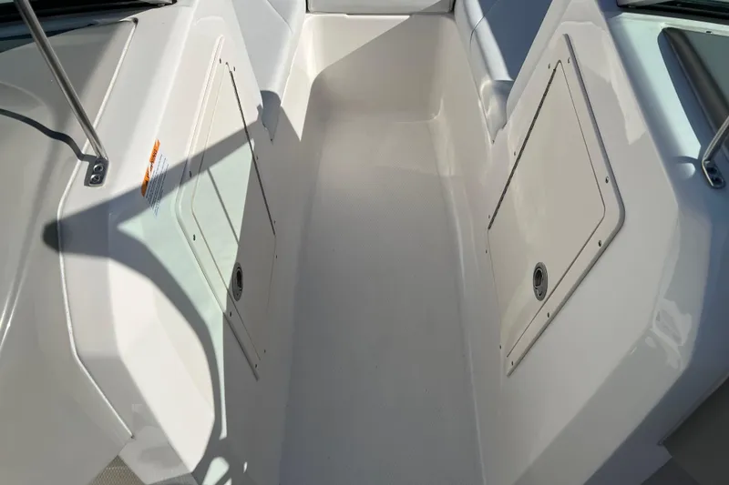Slide: The Image of 2017 Chaparral 19 H2O Sport boat interior with storage compartments. - 9