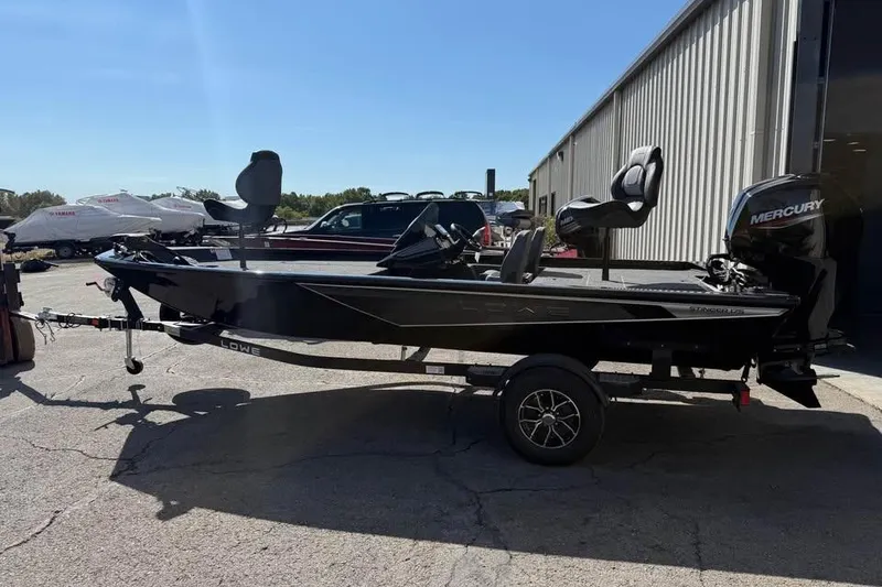 The Image of 2026 Lowe Stinger 175C boat with Mercury engine on trailer, parked outdoors. - 0