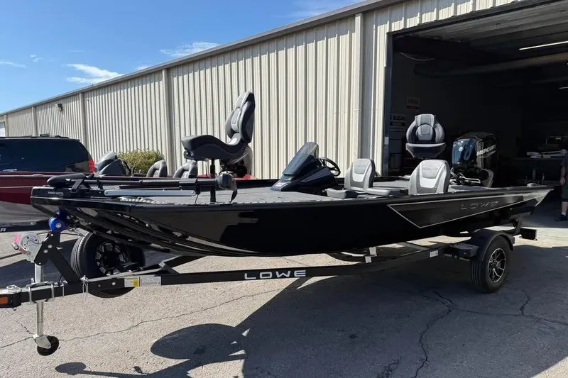 Slide: The Image of 2026 Lowe Stinger 175C boat on trailer outside a warehouse. - 1
