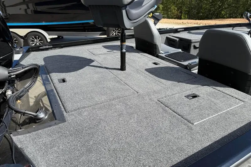 Slide: The Image of 2026 Lowe Stinger 175C boat interior with gray carpeted deck and seating. - 6