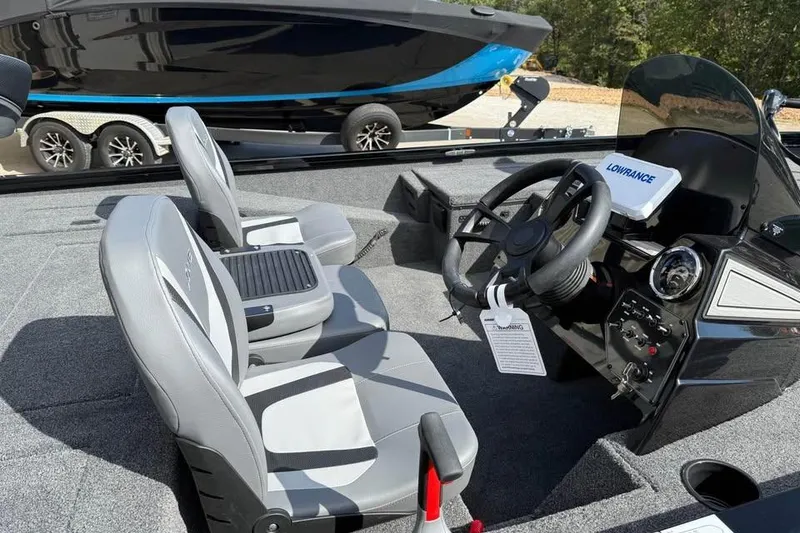 Slide: The Image of Interior of 2026 Lowe Stinger 175C boat with steering wheel and seats. - 7