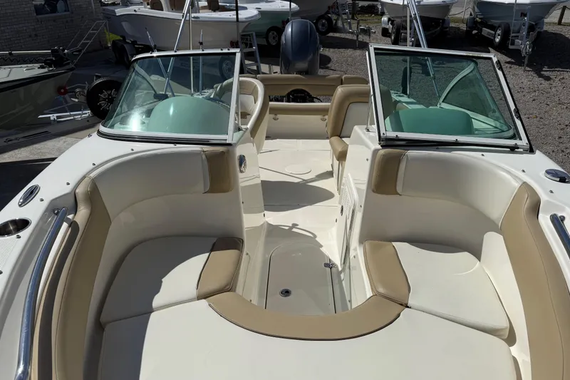 Slide: The Image of 2017 Pioneer 197 Venture boat interior with beige and white seating, open deck layout. - 13