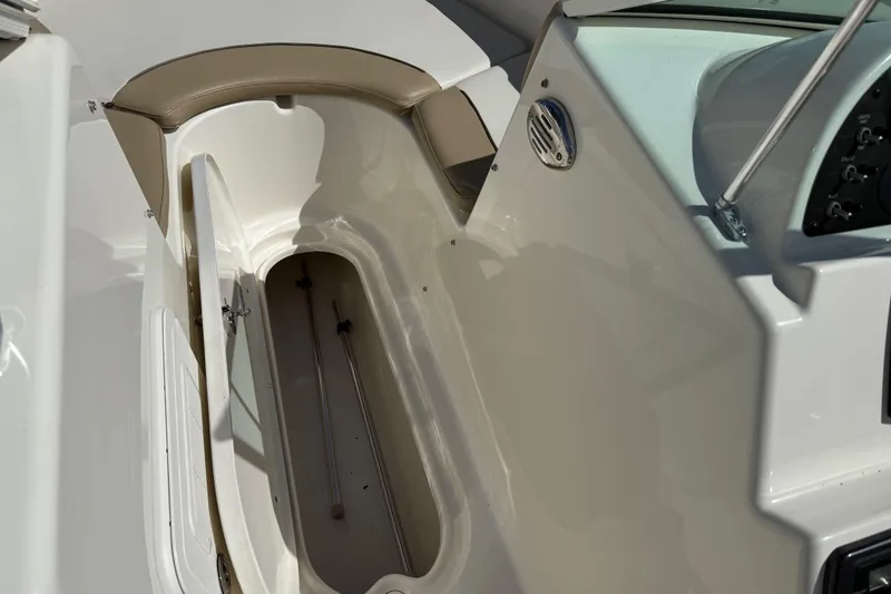 Slide: The Image of 2017 Pioneer 197 Venture boat storage compartment with open hatch and beige seating. - 14