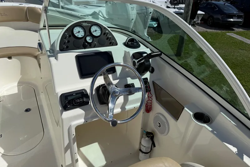 Slide: The Image of 2017 Pioneer 197 Venture boat dashboard with steering wheel and control panel. - 17