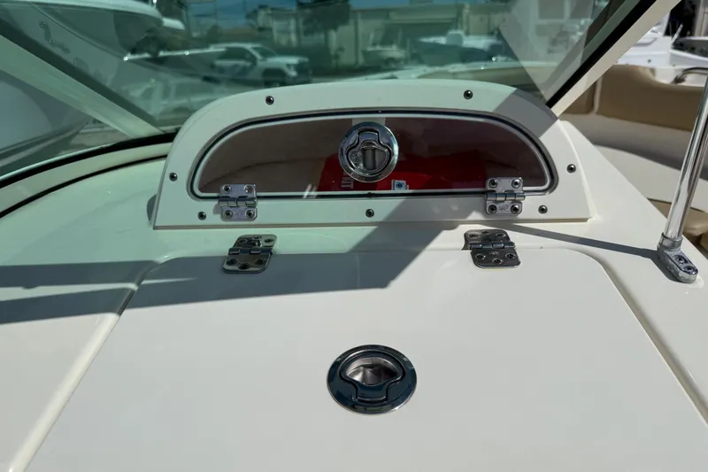 Slide: The Image of 2017 Pioneer 197 Venture boat dashboard with storage compartment and latch. - 24