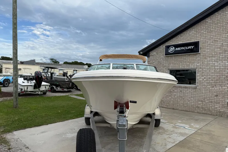 Slide: The Image of 2017 Pioneer 197 Venture boat on trailer near Mercury building, cloudy sky. - 3