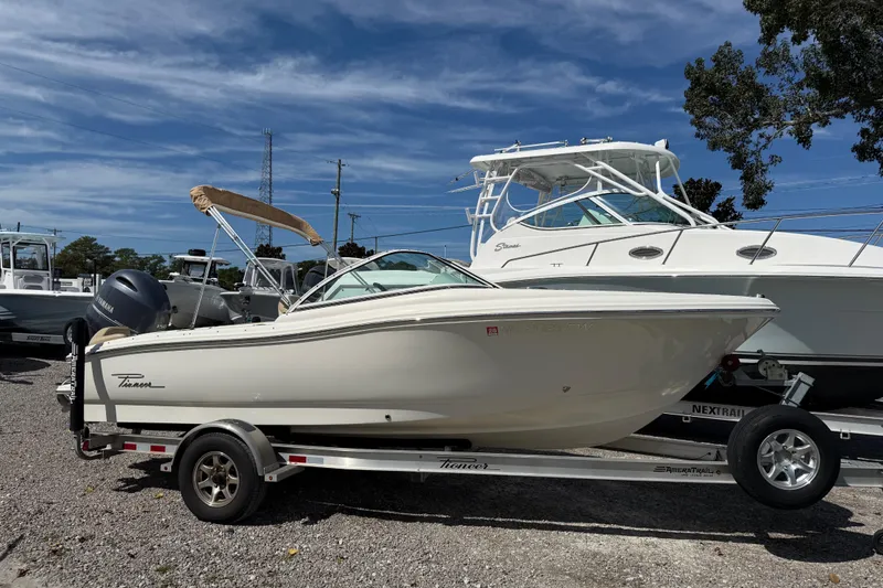 Slide: The Image of 2017 Pioneer 197 Venture boat on trailer, parked outdoors under a clear blue sky. - 30