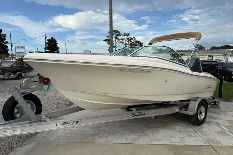 Slide: The Image of 2017 Pioneer 197 Venture boat on trailer, parked outdoors under a cloudy sky. - 4