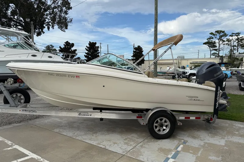 Slide: The Image of 2017 Pioneer 197 Venture boat on trailer, parked outdoors under a cloudy sky. - 5