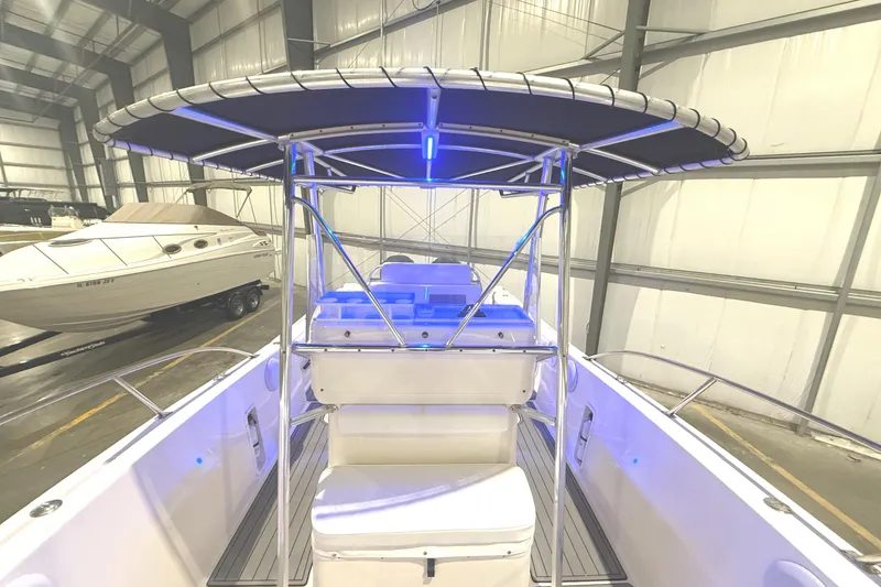 Slide: The Image of 1999 Pursuit 2870 Center Console boat in spacious indoor storage facility. - 11