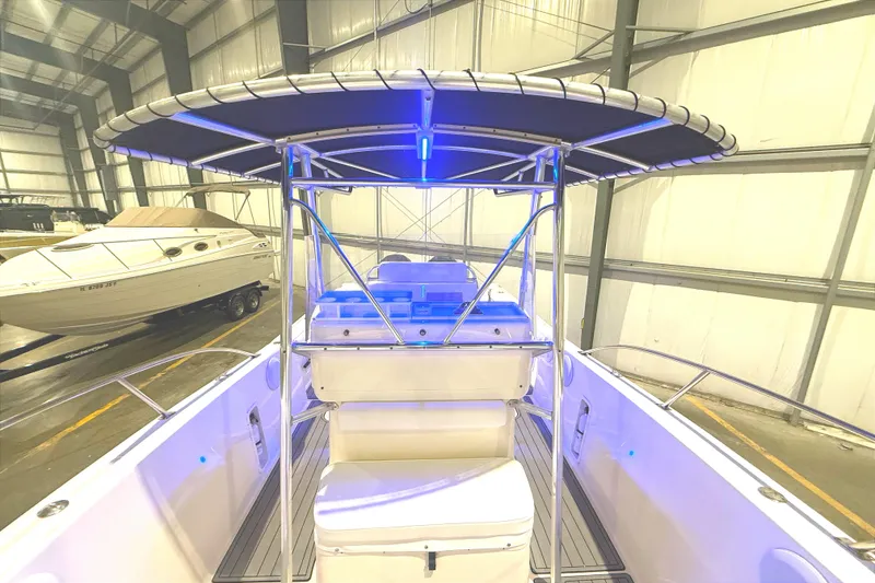 Slide: The Image of 1999 Pursuit 2870 Center Console boat in spacious indoor storage facility. - 12