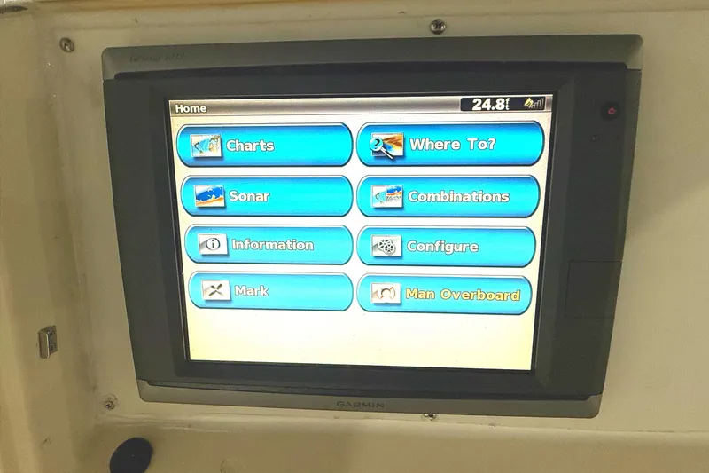 Slide: The Image of 1999 Pursuit 2870 Center Console boat interior with control panel and seating. - 15