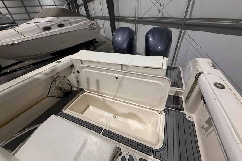 Slide: The Image of 1999 Pursuit 2870 Center Console boat interior with open storage compartment. - 20