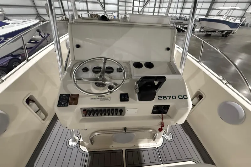 Slide: The Image of 1999 Pursuit 2870 Center Console boat interior with speaker and fire extinguisher. - 25