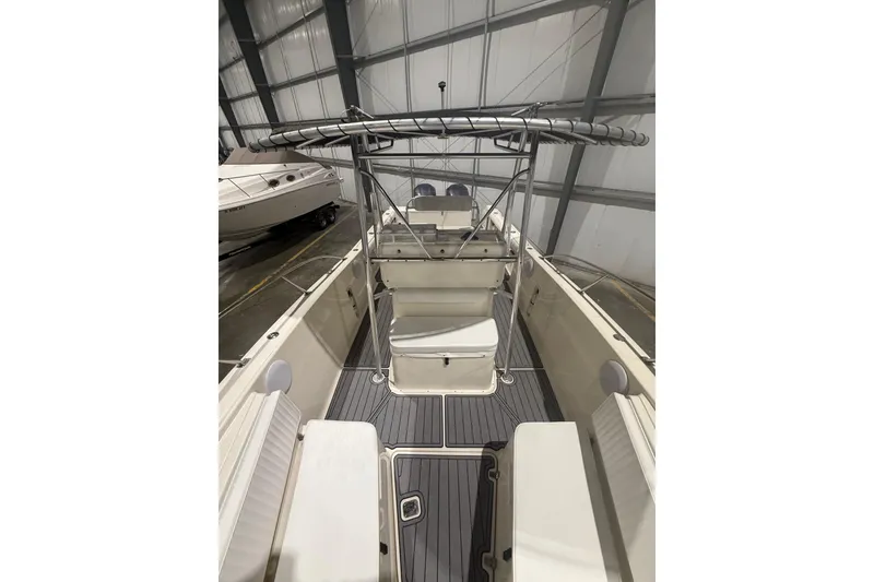 Slide: The Image of 1999 Pursuit 2870 Center Console boat interior with cushioned seating and non-slip flooring. - 28