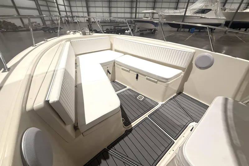Slide: The Image of 1999 Pursuit 2870 Center Console boat interior with cushioned seating and non-slip flooring. - 30