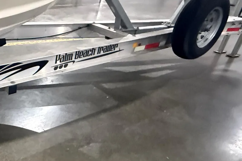 Slide: The Image of 1999 Pursuit 2870 Center Console boat on trailer in warehouse. - 33