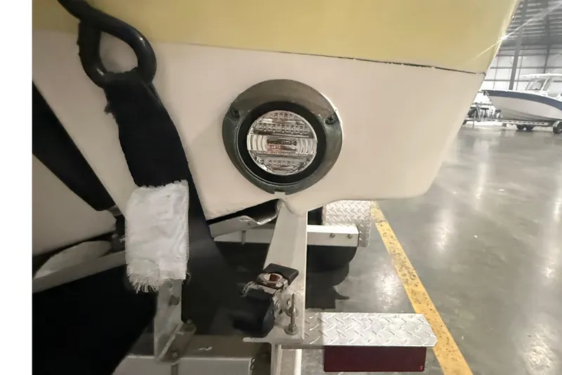 Slide: The Image of 1999 Pursuit 2870 Center Console boat with ladder and trailer in a garage. - 35