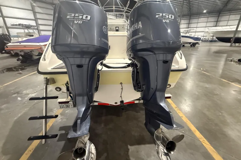 Slide: The Image of 1999 Pursuit 2870 Center Console boat on trailer in warehouse with Yamaha engine. - 36