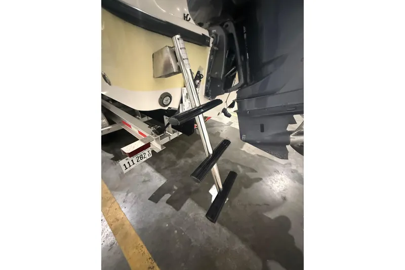 Slide: The Image of 1999 Pursuit 2870 Center Console boat on trailer in indoor storage. - 37