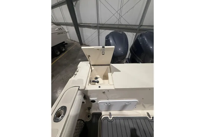 Slide: The Image of 1999 Pursuit 2870 Center Console boat on trailer in warehouse setting. - 41