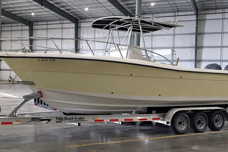 Slide: The Image of 1999 Pursuit 2870 Center Console boat on trailer in indoor storage facility. - 43