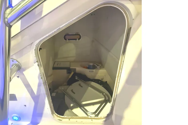 Slide: The Image of 1999 Pursuit 2870 Center Console boat with T-top and blue interior lighting. - 9