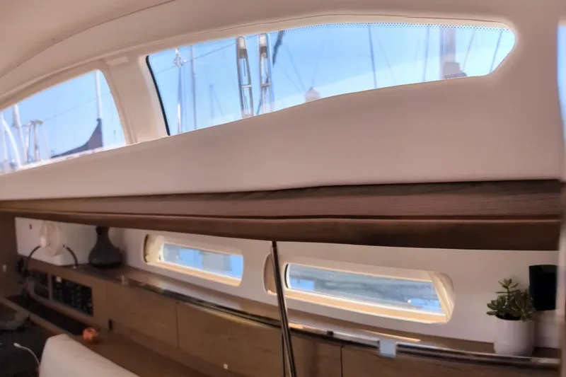 Slide: The Image of Interior view of 2013 Jeanneau Sun Odyssey 44 DS sailboat with sleek windows and wooden accents. - 10