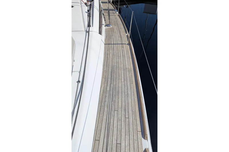 Slide: The Image of Teak deck of 2013 Jeanneau Sun Odyssey 44 DS sailboat, showcasing elegant design. - 4